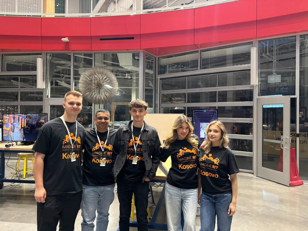 American Academy of Technology university student Klajdi Spahiu posing with other students who are participating in Imagine RIT at the RIT NY campus. 